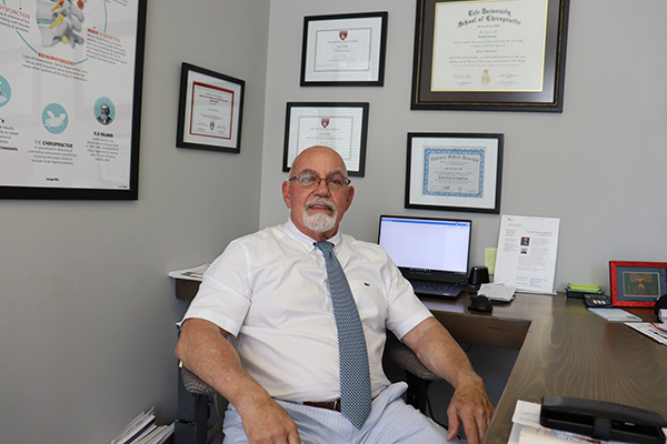 Chiropractor Greenville SC Joe Carrano At Desk